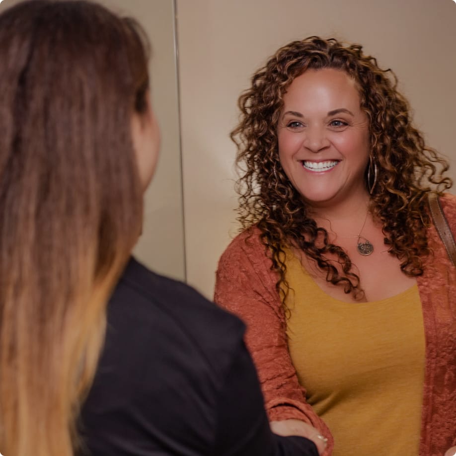 A shot of a woman in her bikini from neck to thigh.